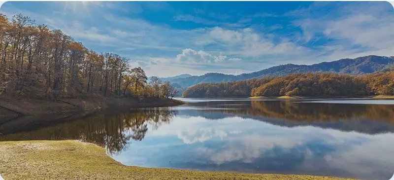 Autumn reflections on a lake in the Lankaran region